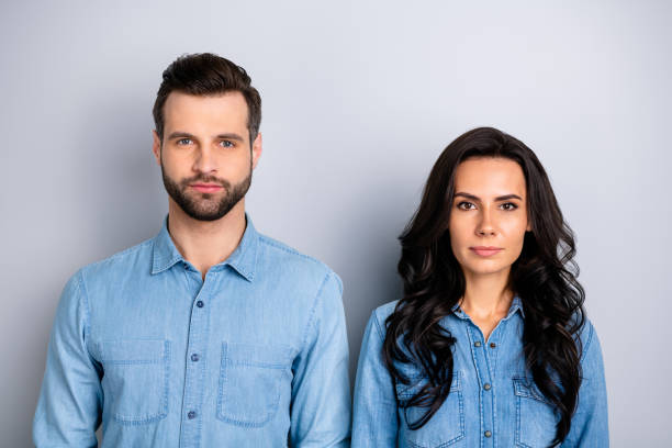 istock Close up portrait of two attractive fellows colleagues thinking about work problems questions listening attentively isolated in blue denim shirts over argent background 1137306895