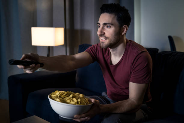 istock Man watching movie at home 1137307171