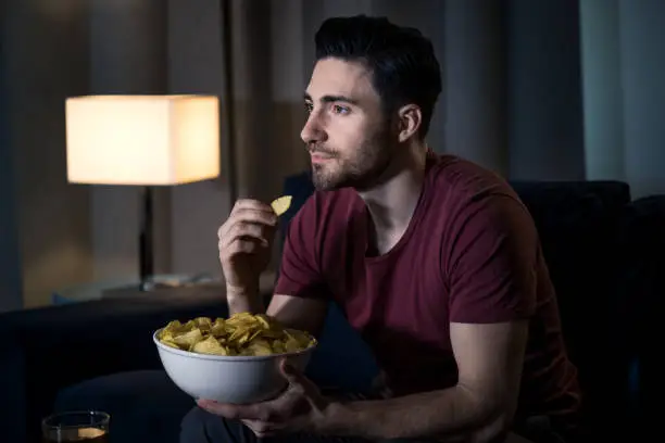 Photo of Man watching movie at home