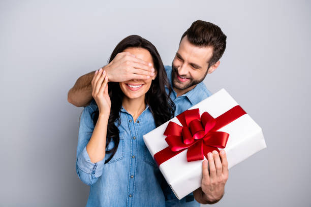 Close up photo amazing she her he him his lady guy hide eyes guess who game prepared romance surprise hold big large giftbox wear casual jeans denim shirts outfit clothes isolated grey background Close up photo amazing she her he him his lady guy hide eyes guess who game prepared romance surprise hold big large giftbox wear casual jeans denim shirts outfit clothes isolated grey background. gift for girlfriend stock pictures, royalty-free photos & images