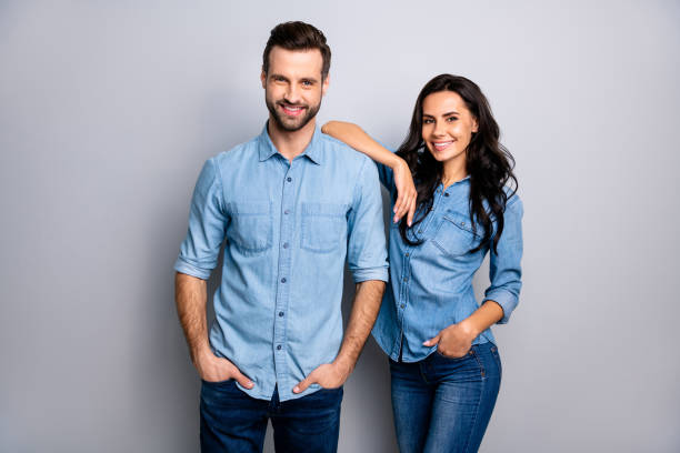 istock Portrait of charming millennial students workers freelancers entrepreneurs take decisions solutions achieve aims touching shoulders by arms dressed in blue denim outfit on ashy-gray isolated 1137308997