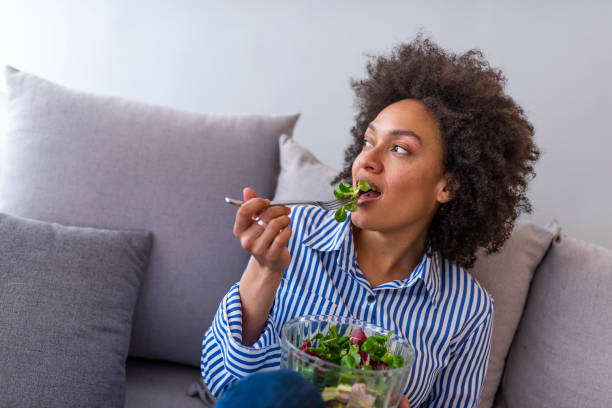 istock Nice joyful woman eating salad. 1137311092