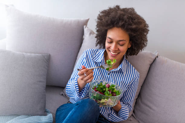 istock Nice joyful woman eating salad. 1137312375