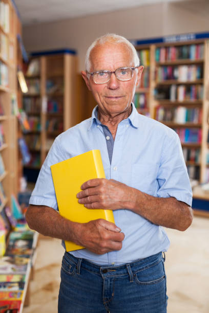 istock Happy elderly man in bookstore 1137313441