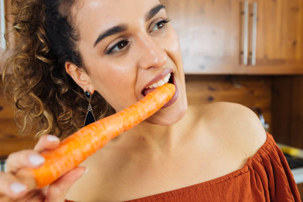 istock Beautiful Woman with a Carrot 1137313553