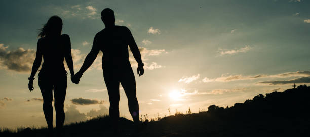 istock Summer sunset at sea and silhouettes. 1137313857