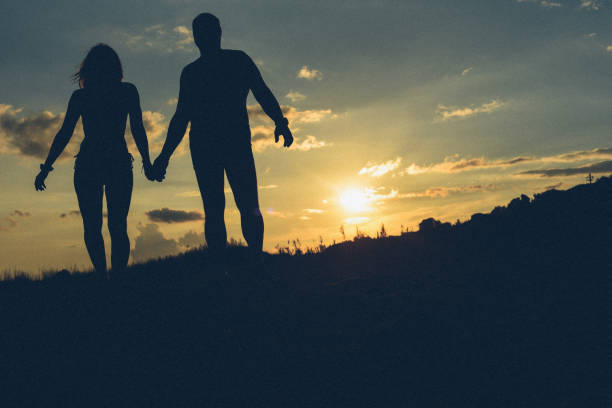 istock Summer sunset at sea and silhouettes. 1137314511