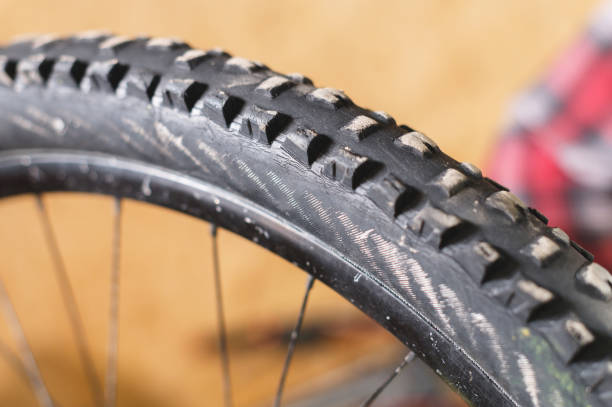 istock Mountain bike tire tread closeup at home workshop 1137317320