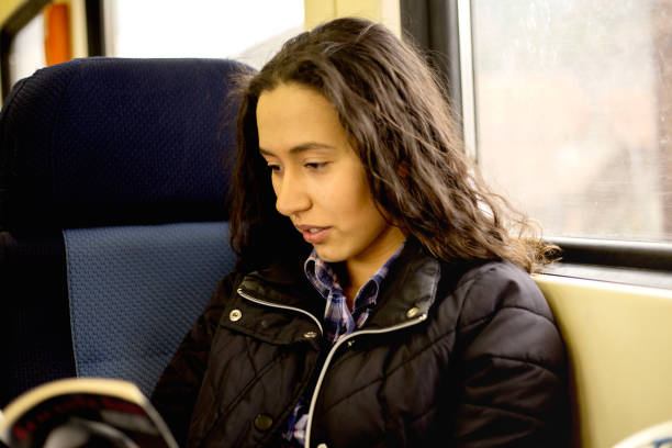 istock Young woman is reading the book on fast train 1137317542