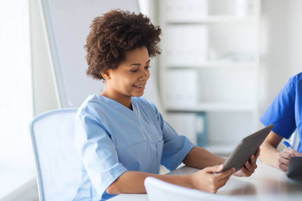 istock happy female doctor or nurse with tablet pc 1137320371