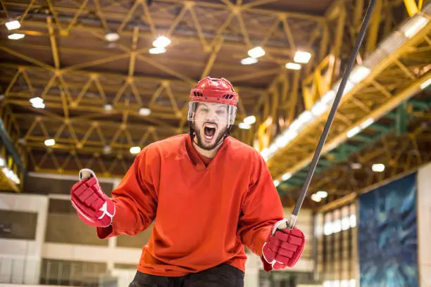 Ice hockey player at an ice hockey rink, celebrating a goal. About 25 years old, Caucasian male.