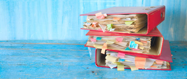 istock stack of messy file folders and documents,red tape concept,free copy space 1137321042