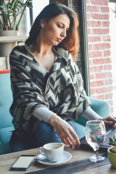 istock Beautiful young woman in cafe 1137325058