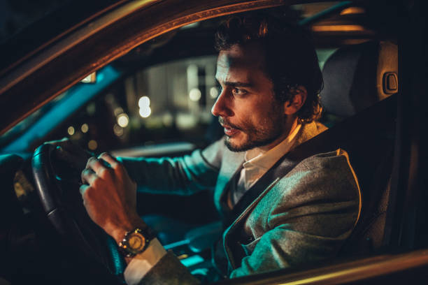 istock Guy driving a car in city at night 1137325798