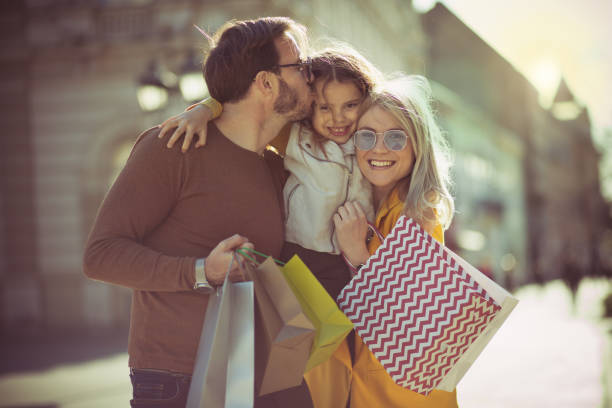 Their little princess. Their little princess. Family in the city. three way kiss stock pictures, royalty-free photos & images