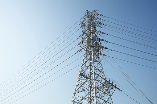 A worker for energy company at the transmission tower