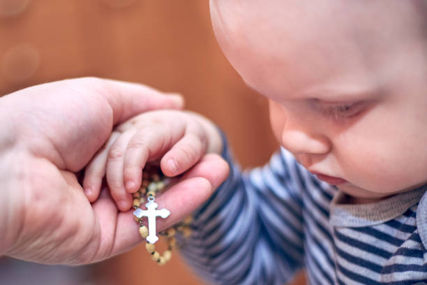 istock A child takes a rosary from his dad's hand 1137332146