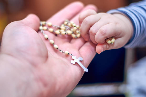 istock A child takes a rosary from his dad's hand 1137332221