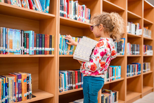 istock Little girl in a library 1137333366