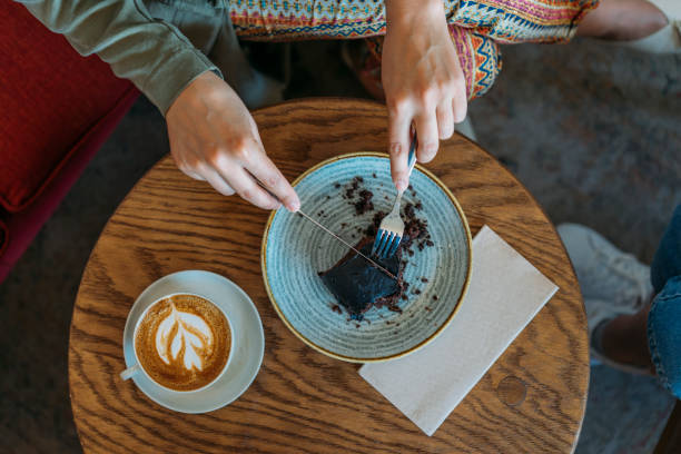 istock High angle view of coffee and cake on the table in a cafe 1137335800