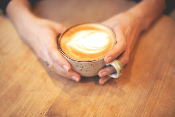 istock Girl holding a cup of coffee 1137336356