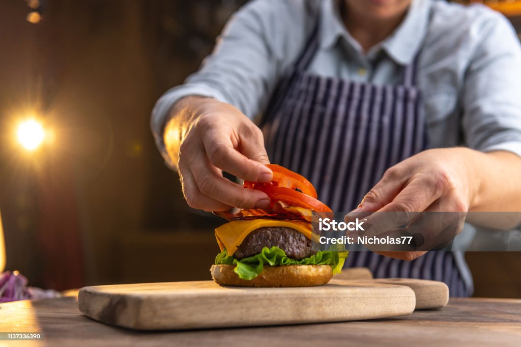 Chef preparing a hamburger Burger Stock Photo