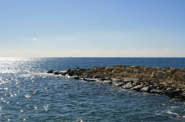 istock Blue sea, sky and stone pier 1137336443