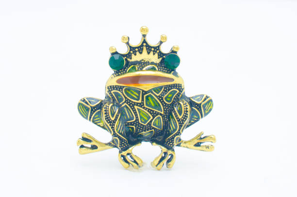 istock golden enamelled brooch frog wearing a crown isolated on white 1137338627