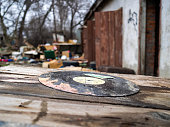Old musical plate on a dump. A dirty plate among garbage