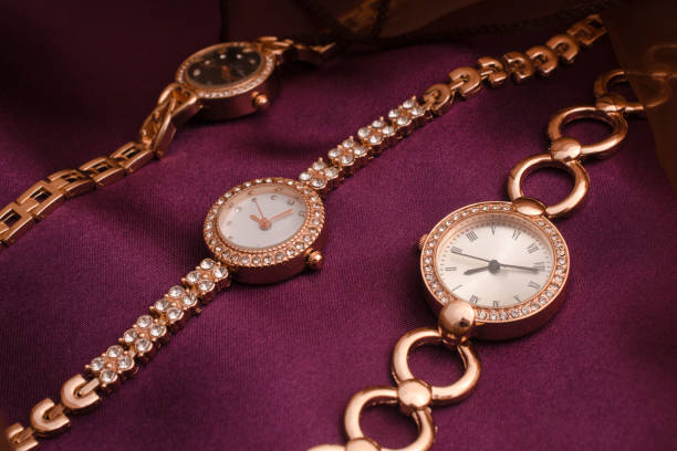 istock three gold women's wrist watches on a silk fabric 1137339776