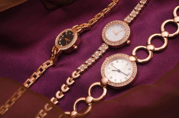 istock three gold women's wrist watches on a silk fabric 1137339780