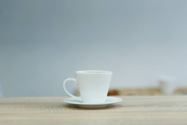 istock Splash in white cup of coffee on wooden table. 1137339941