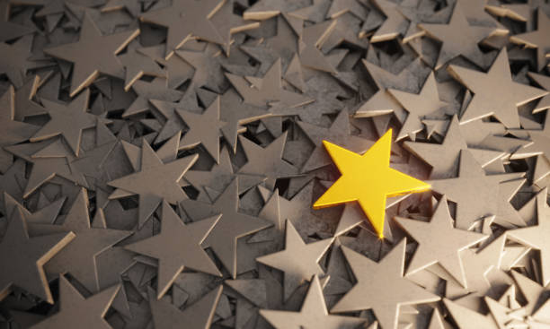 Golden Star Standing Out From The Crowd Scratched golden star standing out from gray colored stars. ( 3d render ) concepts topics stock pictures, royalty-free photos & images