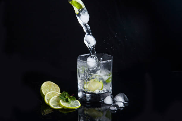 istock Summer cocktail mojito with splash on black background. 1137342992
