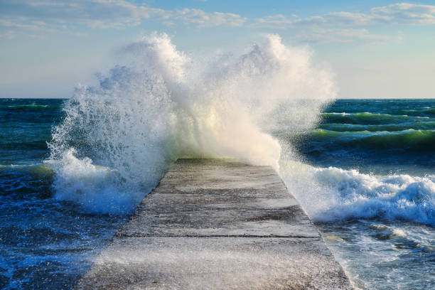 istock surge of waves about the pier 1137344608