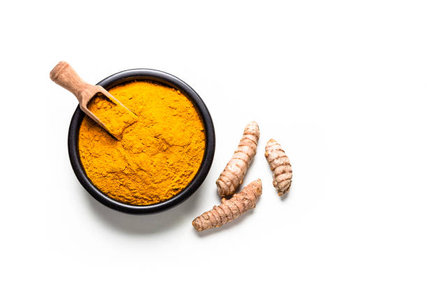 istock Spices: Turmeric powder and roots shot from above on white background 1137344804