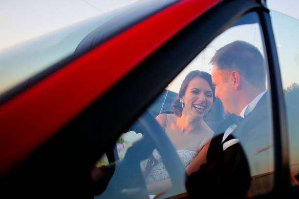 istock Couple watching the sunset in a convertible car. 1137346335