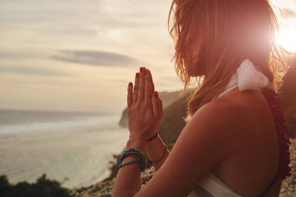 istock Young woman practicing yoga - meditation on the beach. 1137346589