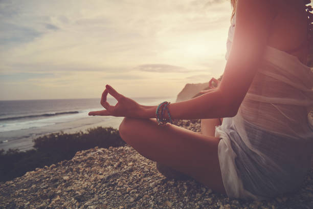 istock Young woman practicing yoga - meditation on the beach. 1137346703