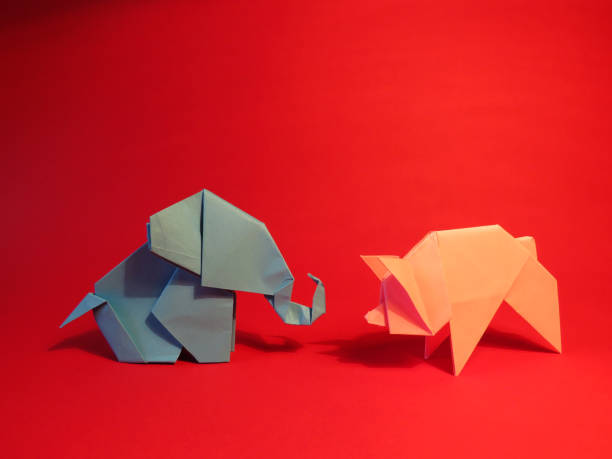 istock Origami blue elephant and pink pig on a red background 1137347287