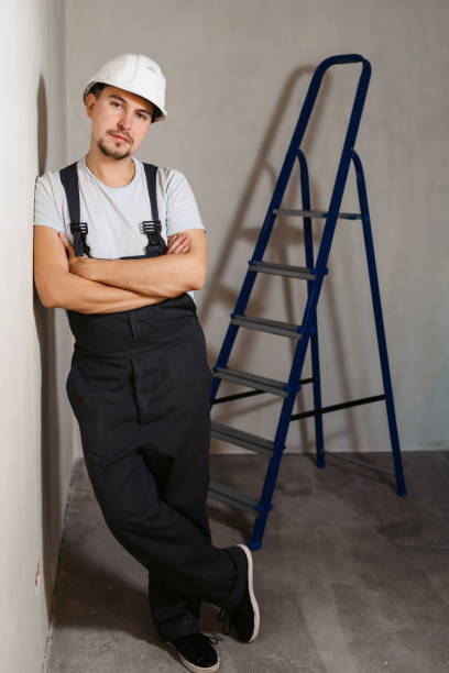 istock Portrait of young man worker industrial engineer in uniform and helmet standing like a boss at white background isolated. Safety equipment. Home renovation concept. Copyspace for text 1137347375