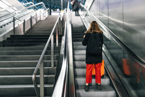istock young woman on escalator in train station 1137347519