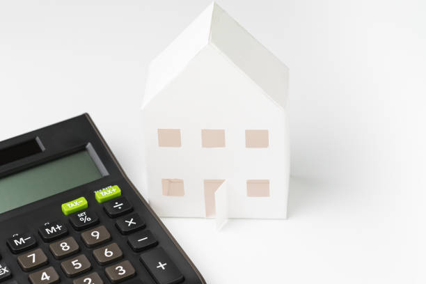 istock white paper house with black calculator on white background using as home loan, mortgate, rental cost and expense or investment in real estate concept 1137347548