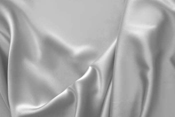 istock Rippled white silk fabric satin cloth waves background 1137348063