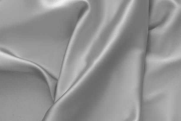 istock Rippled white silk fabric satin cloth waves background 1137348682