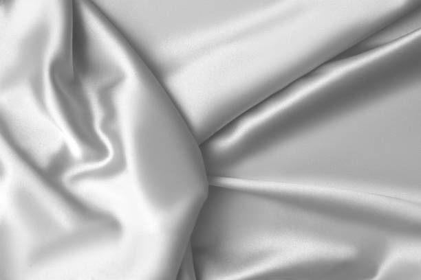 istock Rippled white silk fabric satin cloth waves background 1137348981