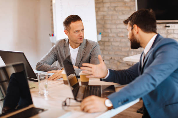 istock Two business men communicate in the office at the table 1137349086