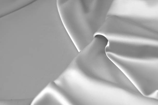 istock Rippled white silk fabric satin cloth waves background 1137349184