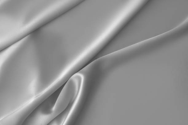 istock Rippled white silk fabric satin cloth waves background 1137349282
