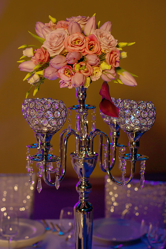 Formal table centerpiece, a beautiful crystal candelabra style candle holder with four hollow-carved designed bowls for candlesticks or tea light candles with a coral flowers vintage bouquet on top.